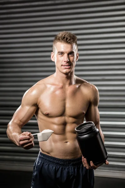 Shirtless man holding protein powder — Stock Photo, Image