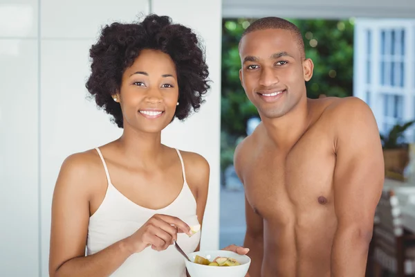 Happy couple eating breakfast in the kitchen — Stock Photo, Image