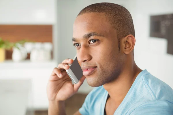 Young man calling in the living room — Stok fotoğraf