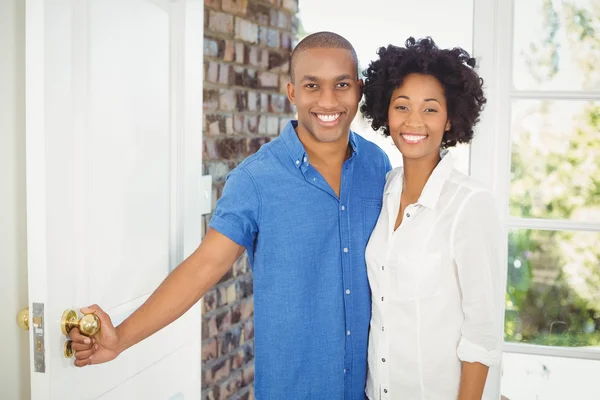 Happy couple about to open the door — Stock Photo, Image