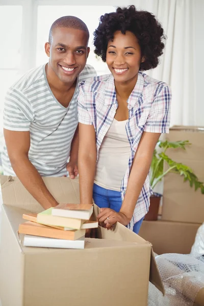 Happy couple opening boxes — Stock Photo, Image
