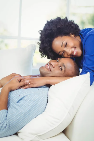 Smiling couple on the sofa — Stok fotoğraf
