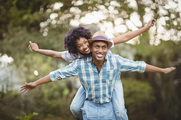 Bonito homem dando porquinho de volta — Fotografia de Stock