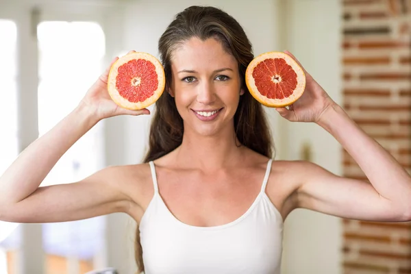 Young woman holding slices of blood orange — 图库照片