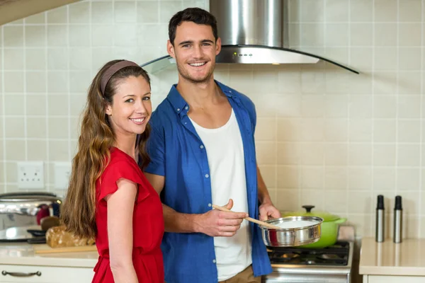 Casal jovem trabalhando juntos na cozinha — Fotografia de Stock