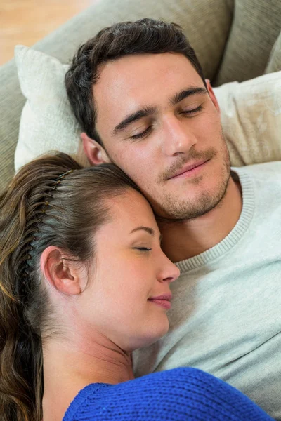 Young couple relaxing together on sofa — Stock Photo, Image