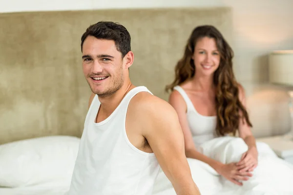 Portrait of young couple relaxing on bed — Stock Photo, Image