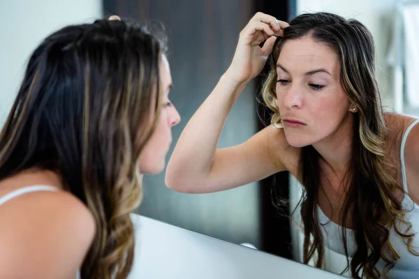 Thoughtful woman looking t her reflection — Stock Photo, Image