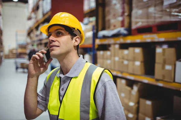 Warehouse worker on a phone call — Stock Photo, Image