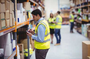 Warehouse worker using hand scanner clipart