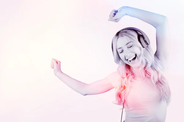 Composite image of beautiful woman dancing with headphones — Stock Photo, Image