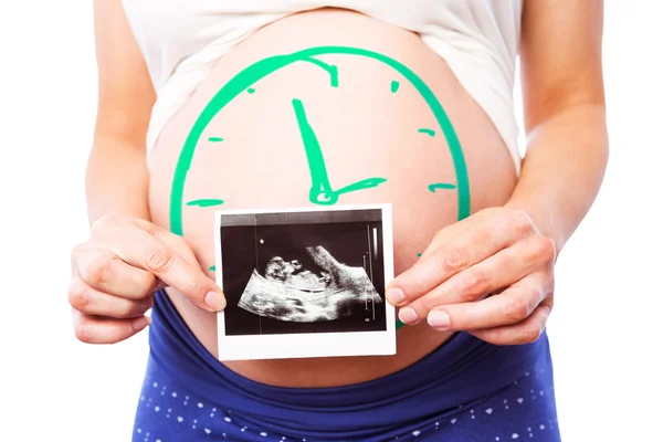 Pregnant woman showing ultrasound scans — Stock Photo, Image