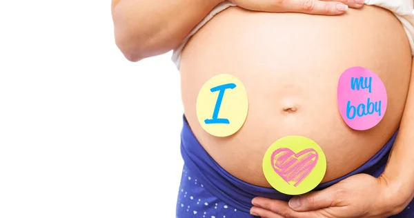 Pregnant woman with stickers on bump — Stock Photo, Image