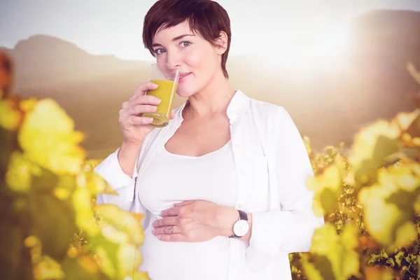Hamile kadın portakal suyu içiyor. — Stok fotoğraf