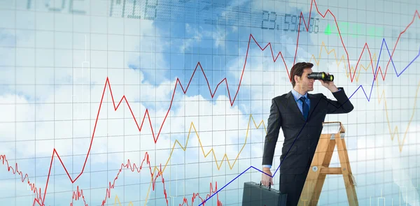 Businessman looking on a ladder — Stock Photo, Image