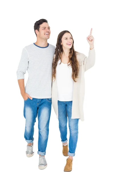 Smiling couple pointing away — Stock Photo, Image