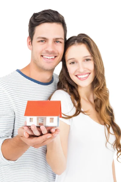 Couple holding miniature house — Stock Photo, Image