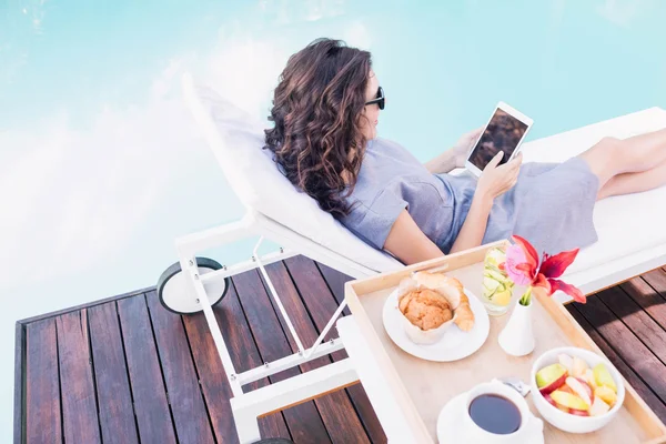 Woman relaxing on sun lounger — Stock Photo, Image