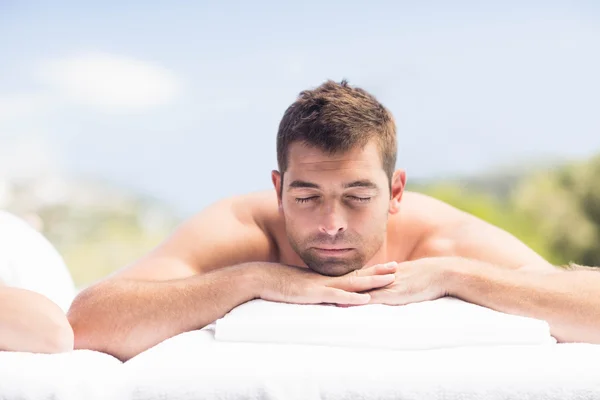 Man relaxing on massage table — Stock Photo, Image