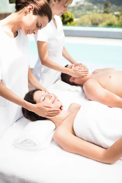 Couple receiving face massage — Stock Photo, Image