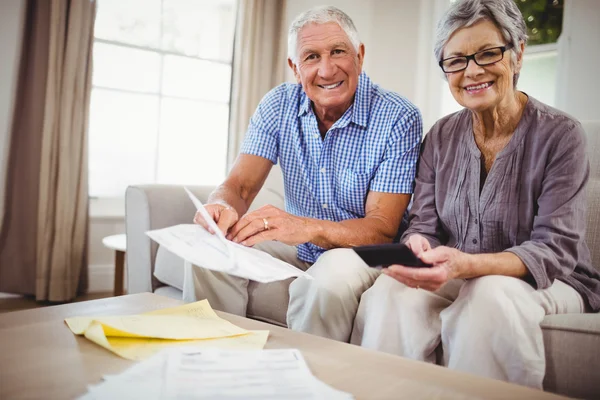 Senior couple sitting on sofa — Stock Photo, Image