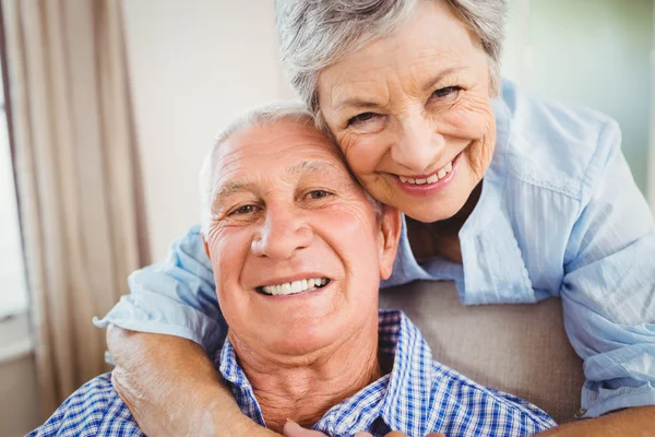 Senior woman embracing man at home — Stock Photo, Image