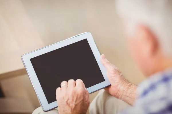 Senior man using digital tablet