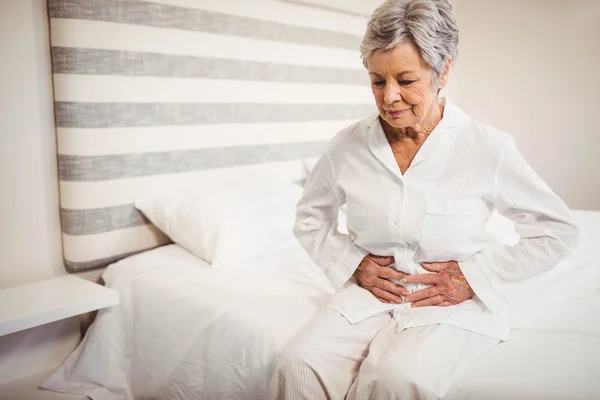 Senior woman suffering from stomach ache — Stock Photo, Image