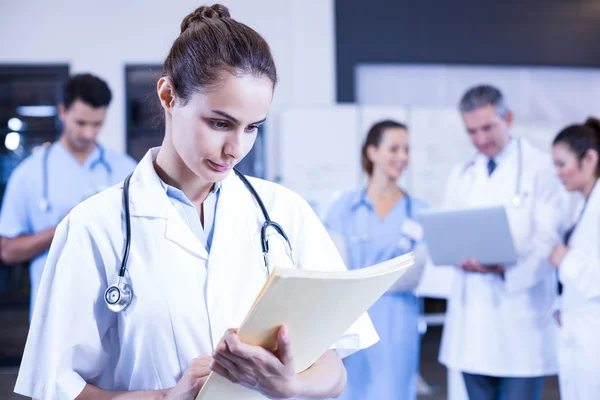 Female doctor checking medical report — Stock Photo, Image