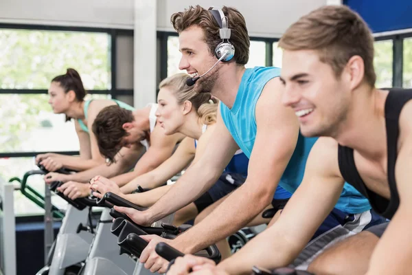 People using exercise bike together — Stock Photo, Image