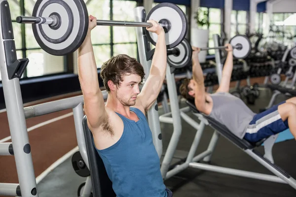 Fit man lifting barbell — Stock Photo, Image