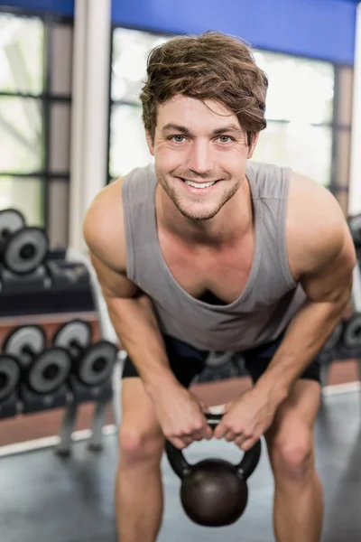 Handsome man lifting dumbbells — Stock Photo, Image