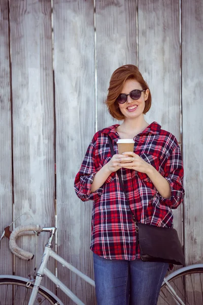 Woman with coffee and bicycle — Stock Photo, Image