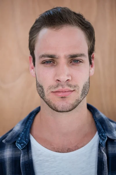 Handsome hipster on wooden background — Stock Photo, Image