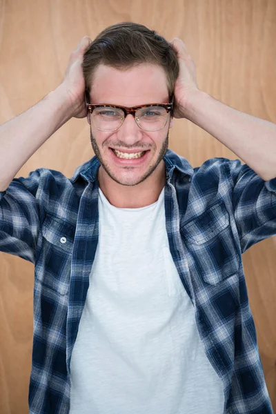 Guapo hipster cubriéndose las orejas —  Fotos de Stock