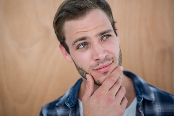 Handsome hipster with hand on chin — Stock Photo, Image