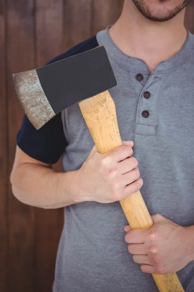 Handsome hipster holding an axe — Stock Photo, Image