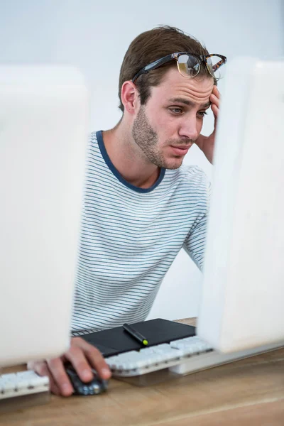 Trött man arbetar på datorn — Stockfoto