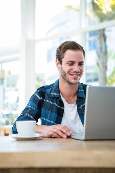 Man working on laptop with cup of coffee — Stock Photo, Image