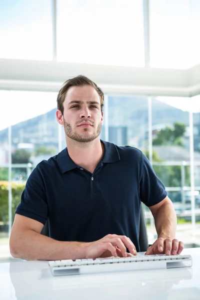 Handsome man using computer — Stock Photo, Image