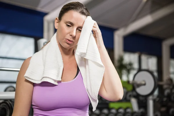 Woman wiping sweat with towel — Stock Photo, Image