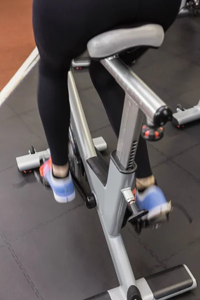 Woman on exercise bike — Stock Photo, Image