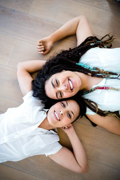 Lesbian couple lying on floor — Stock Photo, Image