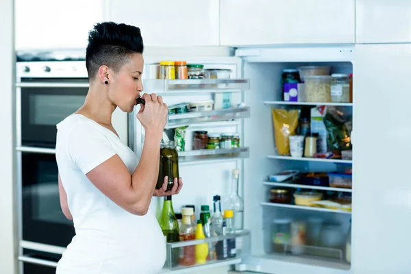 Pregnant woman eating pickles — Stock Photo, Image