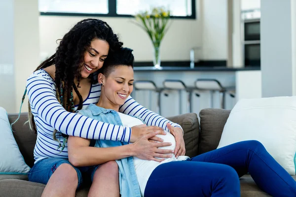 Woman touching pregnant partners stomach — Stock Photo, Image