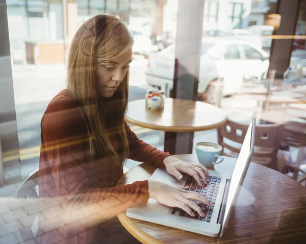 Blonde girl using laptop — Stock Photo, Image