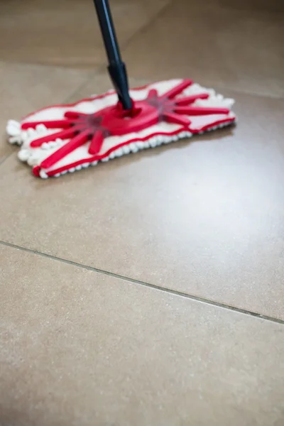 Mop swiping kitchen floor — Stock Photo, Image