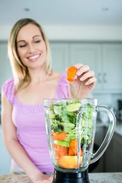 Mulher loira preparando smoothie — Fotografia de Stock