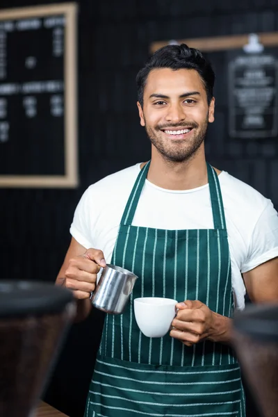 Camarero guapo sirviendo taza de café —  Fotos de Stock