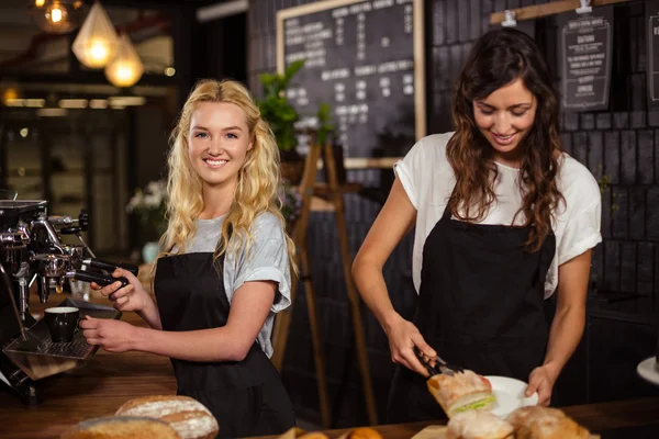 Waitresses behind the counter working — Stock Photo, Image